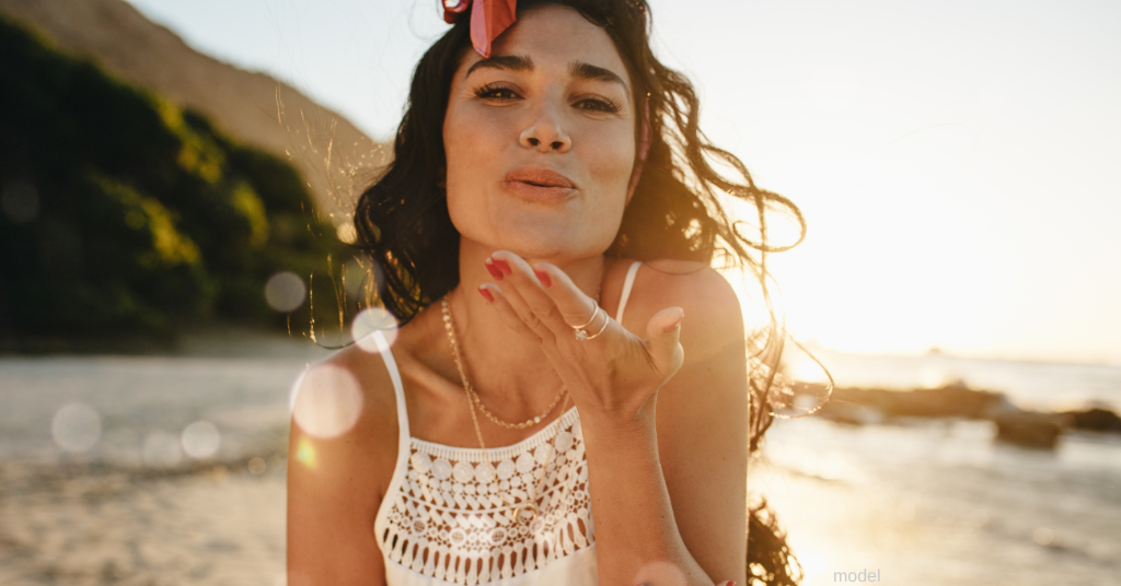 woman happy about BOTOX results at the beach (model)