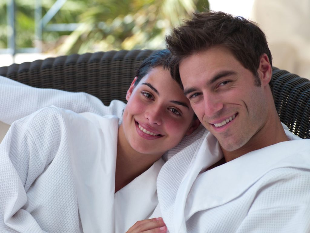 content and confident looking couple in bathrobes with full heads of hair