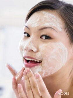 woman putting on facial cream