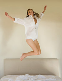 model jumping on bed