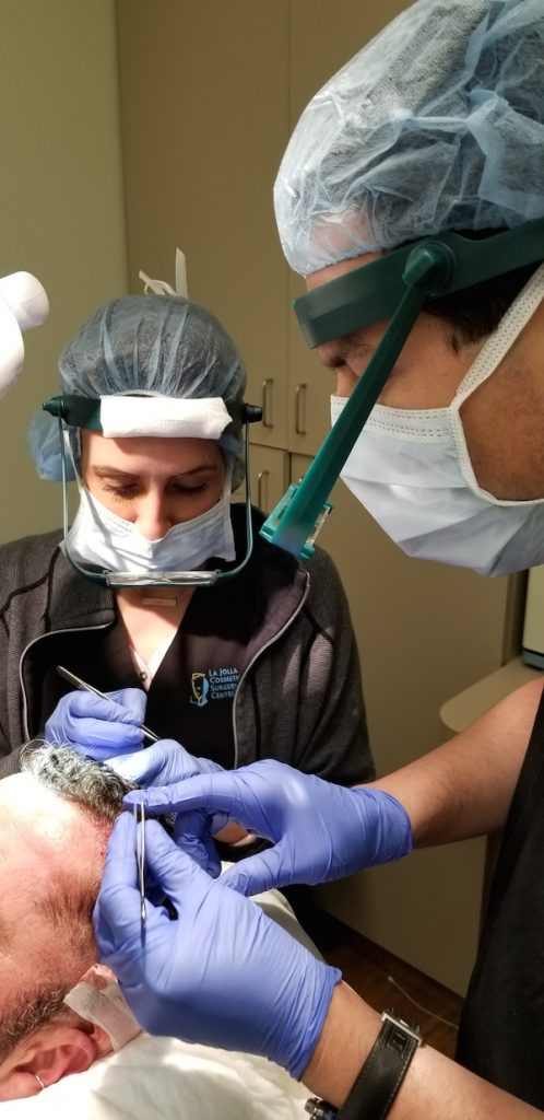 Dr. Salazar performs a SmartGraft hair transplant on a male patient with assistant
