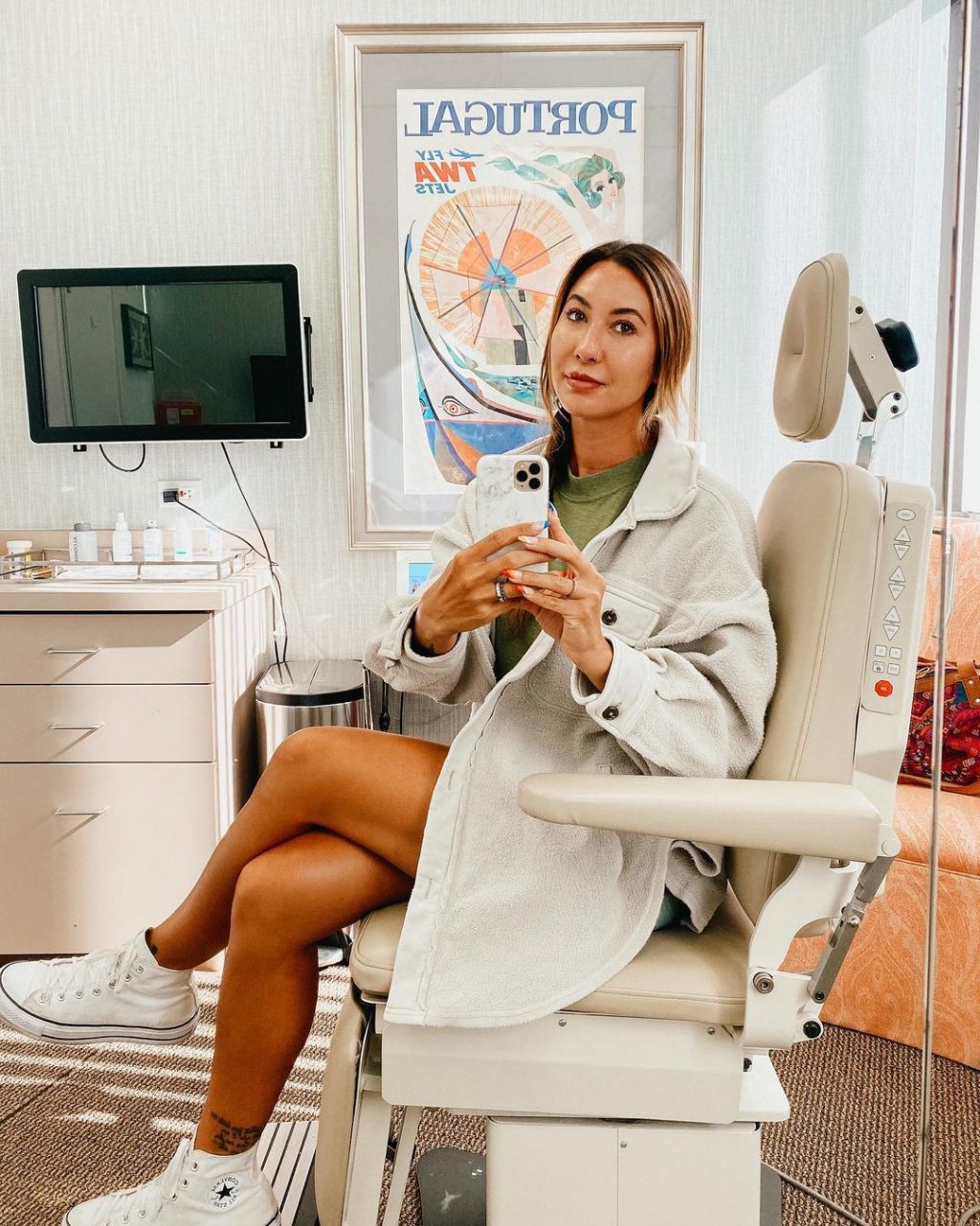 Angeliquea taking a mirror selfie in the office chair at LJC on her NovaThread lift treatment day