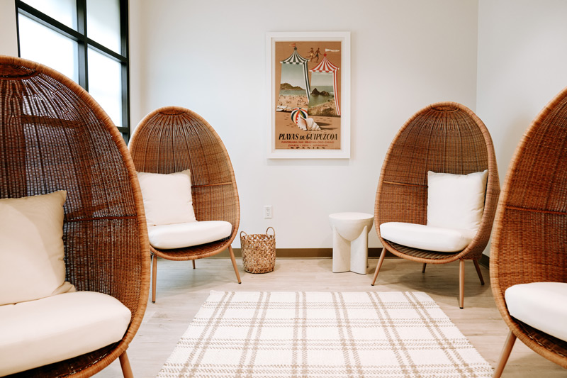 Waiting room of La Jolla Cosmetic Medical Spa in Carlsbad, CA with wicker egg shaped chairs