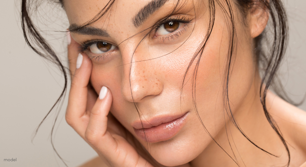 Up close beauty portrait of young brunette with glowing skin