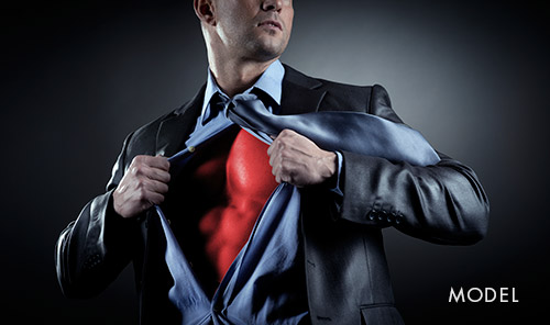 Man in a suit pulling open his shirt to reveal a muscular red chest, posed in a superhero-like stance with the word “Model” in the corner.