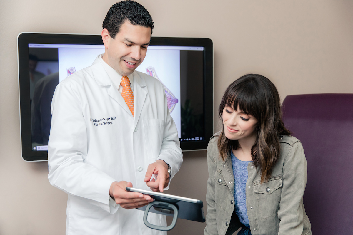 San Diego Spanish Speaking plastic surgeon Dr. Hector Salazar at La Jolla Cosmetic Surgery Centre Board certified plastic surgeon Dr. Hector Salazar with patient at La Jolla Cosmetic Surgery Centre