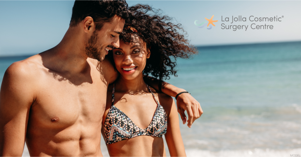 Couple walking on the beach, representing post-weight loss body lift results (models)