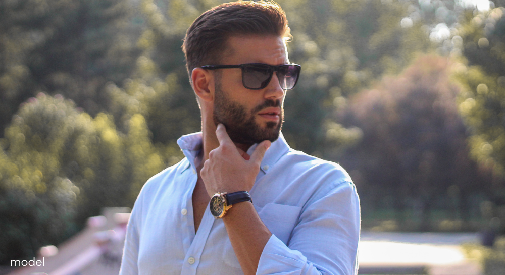 Handsome man in sunglasses looking off into the distance