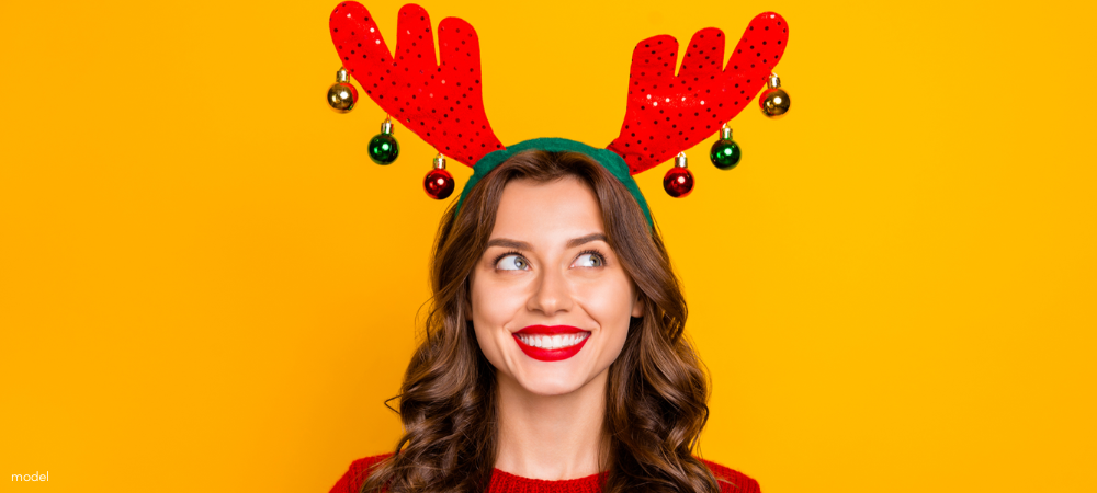 Festive woman wearing reindeer antlers