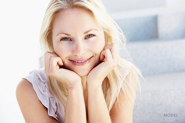 LJC-blonde-smiling-hands-on-face