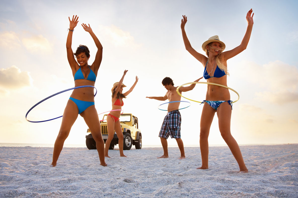 women with Hula-hoops on beach